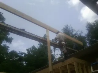 Carpenter setting a ridge beam over a new addition frame — Ice Dam Removal by Roofing Brothers in Blue Mounds